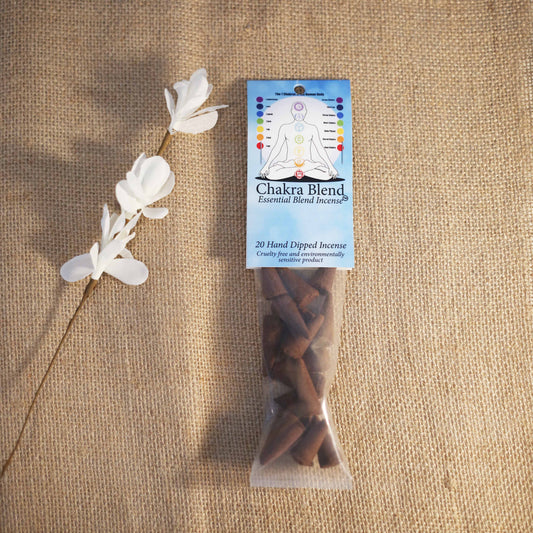 Chakra Blend essential blend incense package with decorative white flowers on a textured brown background