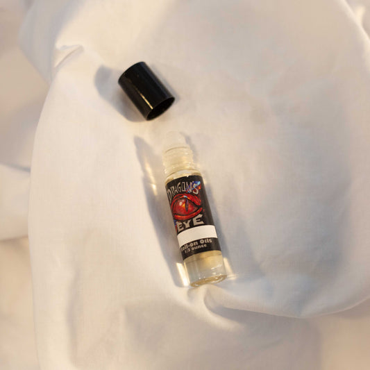 Dragon's Eye aromatherapy roll-on oil in a clear bottle with black lid, labeled 1/3 ounce, featuring a red dragon eye design on the label.